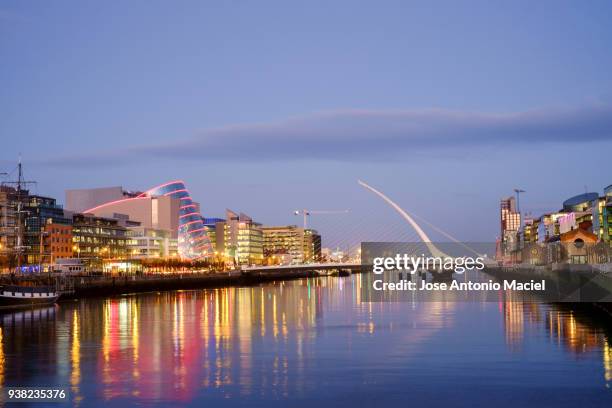 reflections on the liffey river in dublin - dublin skyline stock-fotos und bilder