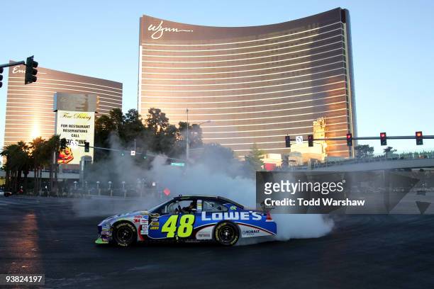 Four time NASCAR Sprint Cup Champion Jimmie Johnson, driver of the Lowe's Chevrolet, does a burnout in front of the Wynn Las Vegas during the Victory...