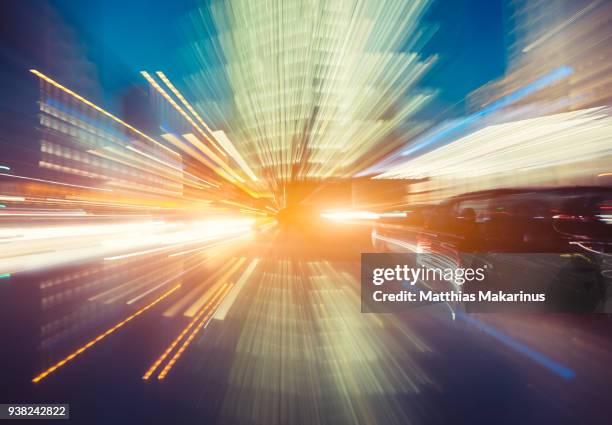 modern creative zoom rush hour night street szene in berlin with traffic lights - matthias makarinus stock-fotos und bilder