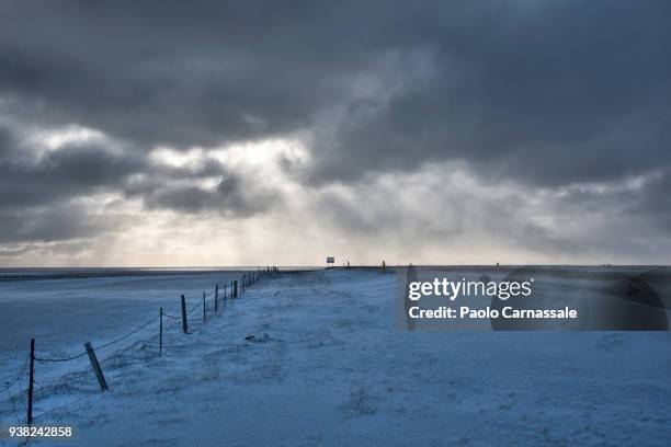 snowy plain with dramatic sky near hellnar, iceland - hellnar stock pictures, royalty-free photos & images