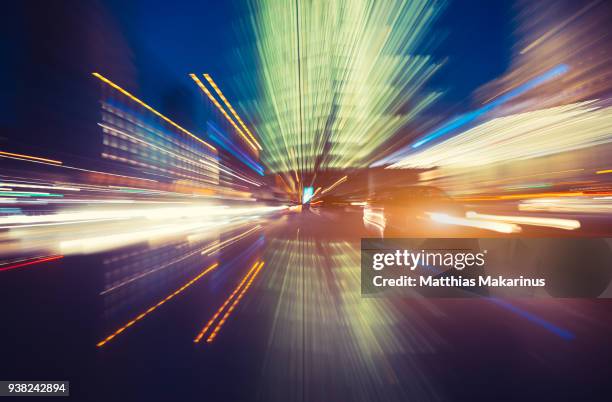 modern creative zoom rush hour night street szene in berlin with traffic lights - matthias makarinus stock-fotos und bilder