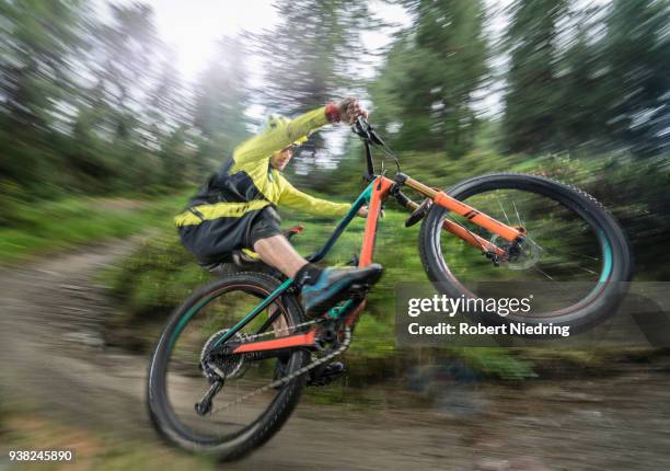 man doing a wheelie with mountain bike, trentino-alto adige, italy - schutzbrille foto e immagini stock