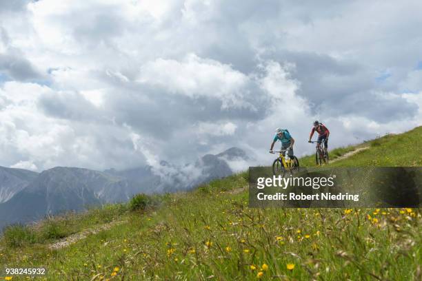 mountain bikers riding down hill, trentino-alto adige, italy - ganzkörperansicht photos et images de collection