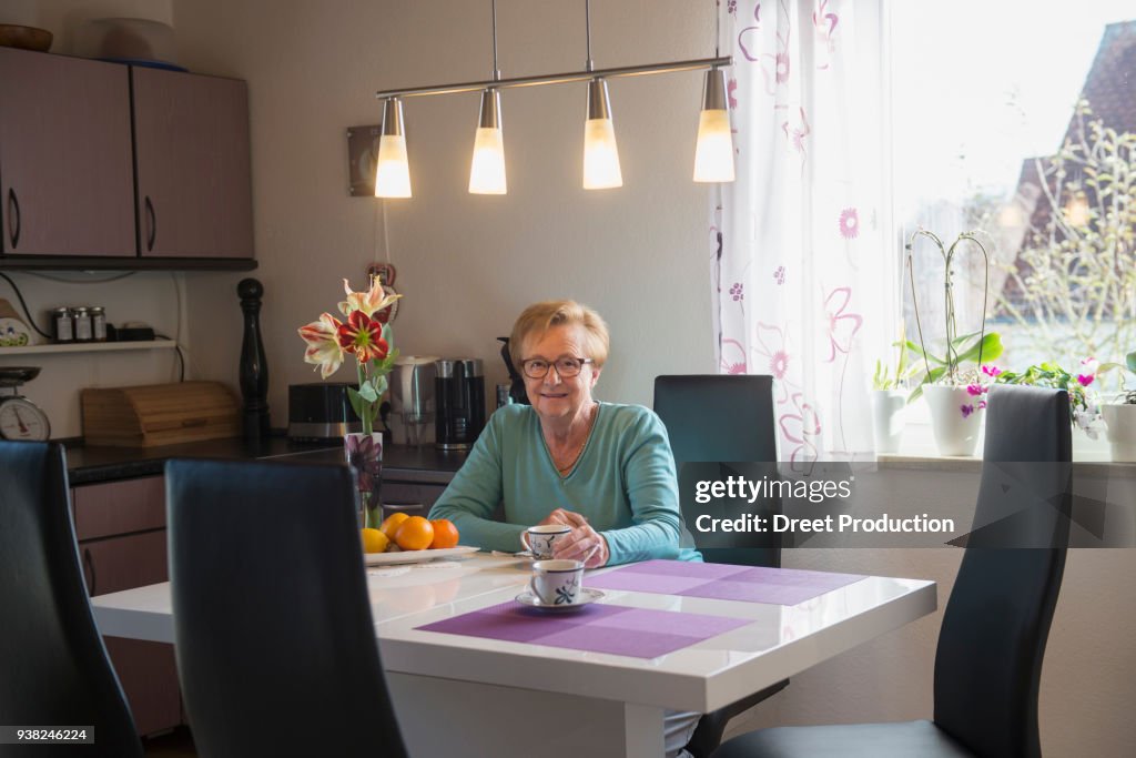 Senior woman drinking coffee at home