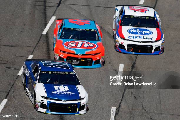 Alex Bowman, driver of the Nationwide Chevrolet, leads Darrell Wallace Jr., driver of the STP Chevrolet, and AJ Allmendinger, driver of the Kroger...