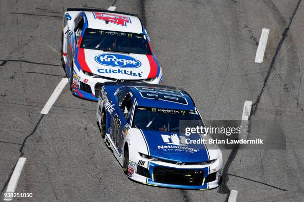 Alex Bowman, driver of the Nationwide Chevrolet, leads AJ Allmendinger, driver of the Kroger ClickList Chevrolet, during the weather delayed Monster...