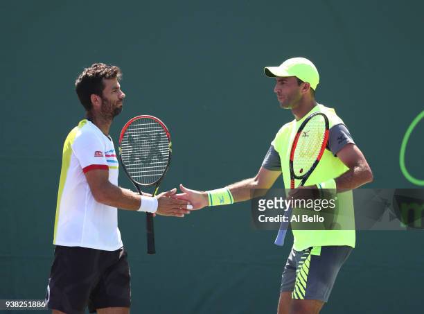 Jean Julien Rojer of the Netherlands and Horia Tecau of Romania play against Ben McLachlan of Japan and Jan Leonard Struff of Germany during Day 8 of...