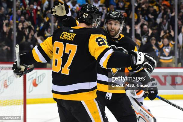 Bryan Rust of the Pittsburgh Penguins is congratulated by teammate Sidney Crosby after scoring the game winning goal in overtime against the...