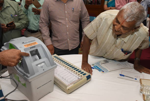 Media person is seen checking a Voter-Verified Paper Audit Trail machine during a demonstration to the media at a city hotel on March 26, 2018 in...