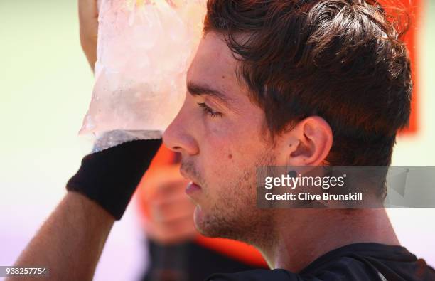 Thanasi Kokkinakis of Australia cools down with an ice bag against Fernando Verdasco of Spain in their third round match during the Miami Open...
