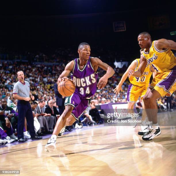 Ray Allen of the Milwaukee Bucks drives to the basket against Byron Scott of the Los Angeles Lakers circa 1997 at the Great Western Forum in...