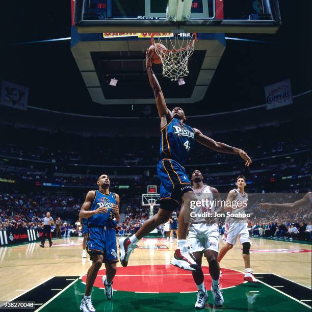 Jerry Stackhouse of the Detroit Pistons dunks the ball during the game against the LA Clippers circa 1998 at Arrowhead Pond of Anaheim in Anaheim,...
