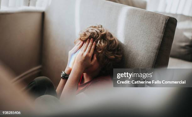 boy covering his eyes - scared boy imagens e fotografias de stock