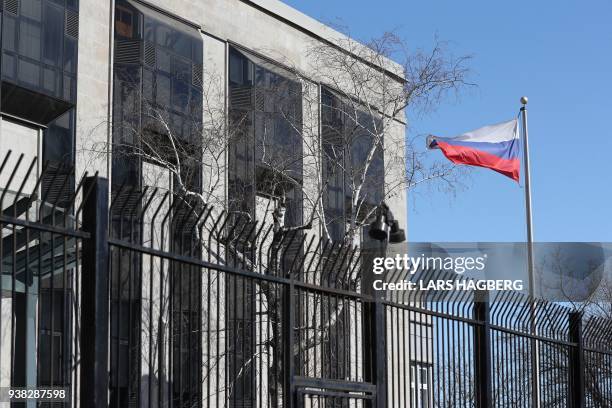 The Russian flag flies at the Russian Embassy in Ottawa, Ontario, on March 26, 2018. - The United States joined Britain's allies in Europe and around...