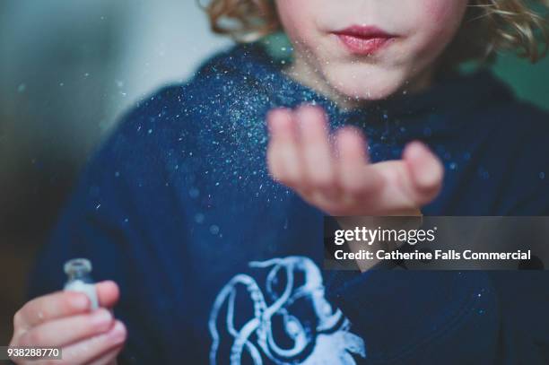 blowing glitter - sparkle children stock pictures, royalty-free photos & images