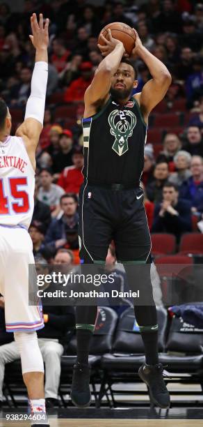 Jabari Parker of the Milwaukee Bucks shoots over Denzel Valentine of the Chicago Bulls at the United Center on March 23, 2018 in Chicago, Illinois....