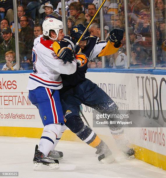 Ryan White of the Montreal Canadiens checks Henrik Tallinder of the Buffalo Sabres into the endboards on December 3, 2009 at HSBC Arena in Buffalo,...