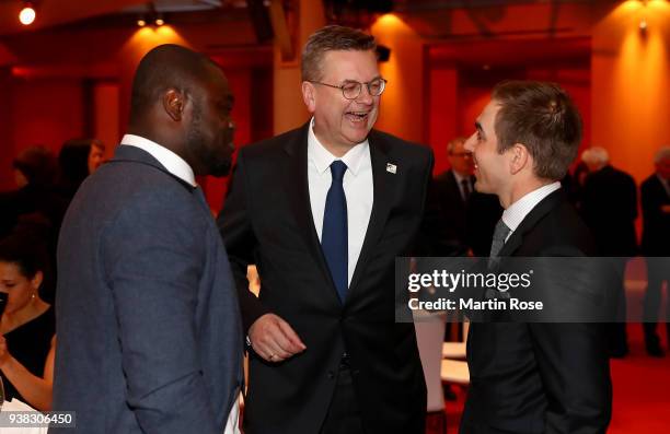 Reinhard Grindel , president of the German football federation jokes with Gerald Asamoah and Philipp Lahm during Integration Prize Awarding Ceremony...