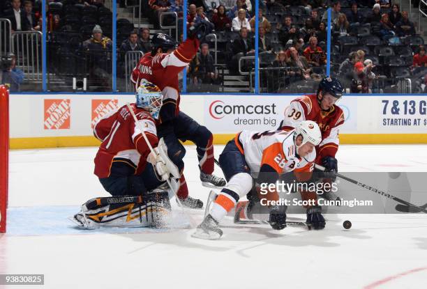Tobias Enstrom of the Atlanta Thrashers defends the goal against Tim Jackman of the New York Islanders at Philips Arena on December 3, 2009 in...
