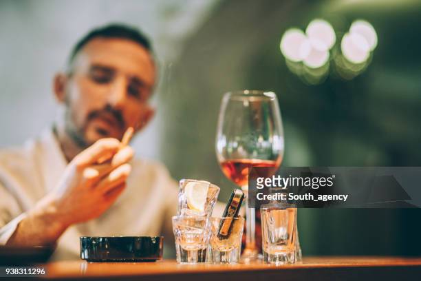 man drinking and smoking - smoke stock pictures, royalty-free photos & images