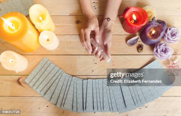 fortune teller female hands and tarot cards on wooden table - tarot cards stock-fotos und bilder