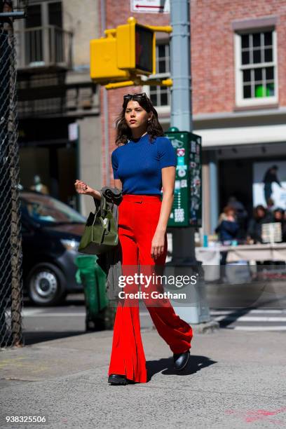 Georgia Fowler is seen wearing Khaite pants, an Une Heures top with an Elleme handbag, Bec & Bridge sunglasses and Altuzarra boots in SoHo on March...