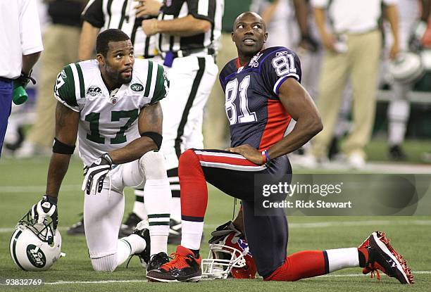 Braylon Edwards of the New York Jets and Terrell Owens of the Buffalo Bills look on during a stop in play at Rogers Centre on December 3, 2009 in...