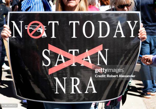 Woman holds an anti-NRA sign at a 'March For Our Lives' rally in Santa Fe, New Mexico. The rally and march, part of a nationwide series of similar...