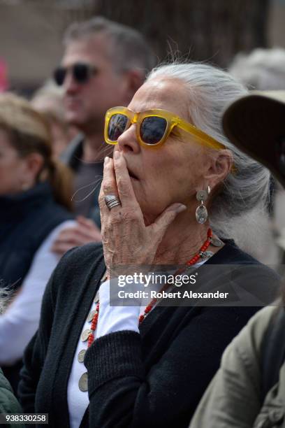 Actress Ali Macgraw reacts to an emotional address by a high school student at a 'March For Our Lives' rally in Santa Fe, New Mexico. The rally and...