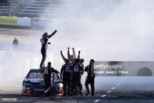 Clint Bowyer, driver of the Haas Automation Demo Day Ford, celebrates winning the weather delayed Monster Energy NASCAR Cup Series STP 500 at...