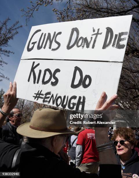 School teacher wears a sign around his neck expressing his opposition to arming teachers during a 'March For Our Lives' rally in Santa Fe, New...