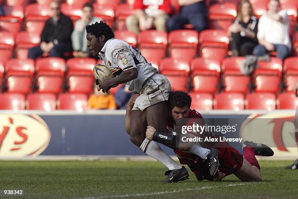 Waine Price of Castleford Tigers is tackled by Andy Farrell of Wigan Warriors during the Tetley's Super League match played at The JJB Stadium, in...