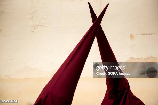 Two penitents from the "Trabajo y Luz" brotherhood during the Holy Monday in Granada, Spain. Every year thousands of christians believers celebrates...