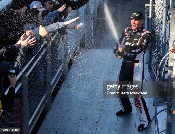 Clint Bowyer, driver of the Haas Automation Demo Day Ford, celebrates winning the weather delayed Monster Energy NASCAR Cup Series STP 500 at...