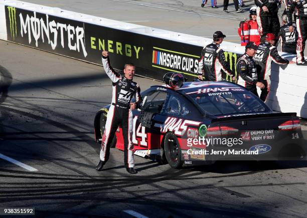 Clint Bowyer, driver of the Haas Automation Demo Day Ford, celebrates winning the weather delayed Monster Energy NASCAR Cup Series STP 500 at...