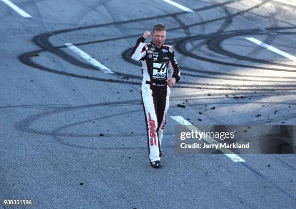 Clint Bowyer, driver of the Haas Automation Demo Day Ford, celebrates winning the weather delayed Monster Energy NASCAR Cup Series STP 500 at...