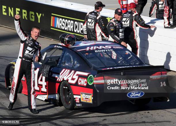 Clint Bowyer, driver of the Haas Automation Demo Day Ford, celebrates winning the weather delayed Monster Energy NASCAR Cup Series STP 500 at...