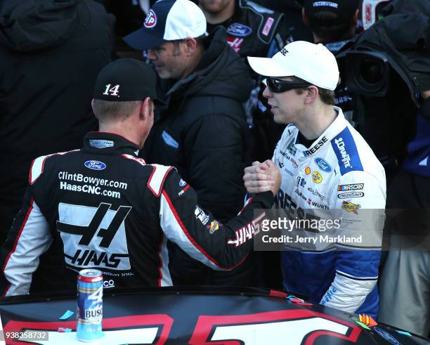 Clint Bowyer, driver of the Haas Automation Demo Day Ford, is congratulated in Victory Lane by Brad Keselowski, driver of the Reese/DrawTite Ford,...