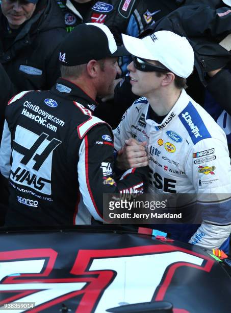 Clint Bowyer, driver of the Haas Automation Demo Day Ford, is congratulated in Victory Lane by Brad Keselowski, driver of the Reese/DrawTite Ford,...