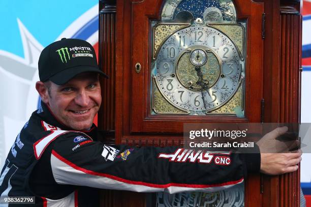 Clint Bowyer, driver of the Haas Automation Demo Day Ford, celebrates with the trophy in Victory Lane after winning the weather delayed Monster...