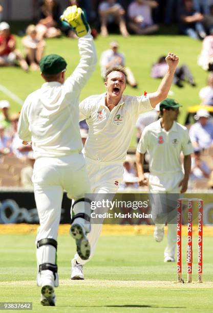 Doug Bollinger and Brad Haddin of Australia celebrate dismissing Chris Gayle of the West Indies during day one of the Second Test match between...