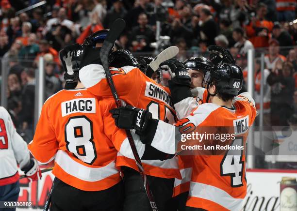 Robert Hagg, Radko Gudas, Valitteri Filppula and Jordan Weal of the Philadelphia Flyers mob Wayne Simmonds following his third period goal against...