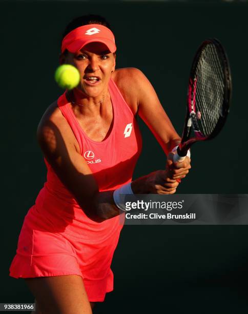 Agnieszka Radwanska of Poland plays a backhand against Victoria Azarenka of Belarus in their fourth round match during the Miami Open Presented by...