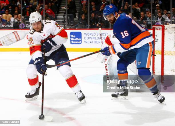 Andrew Ladd of the New York Islanders and Mark Pysyk of the Florida Panthers battle for the puck during the first period at Barclays Center on March...