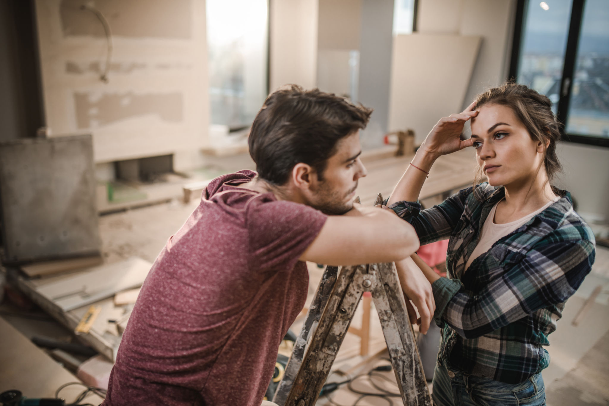 Young couple worrying about renovation of their apartment. Young couple worrying about renovation of their apartment.