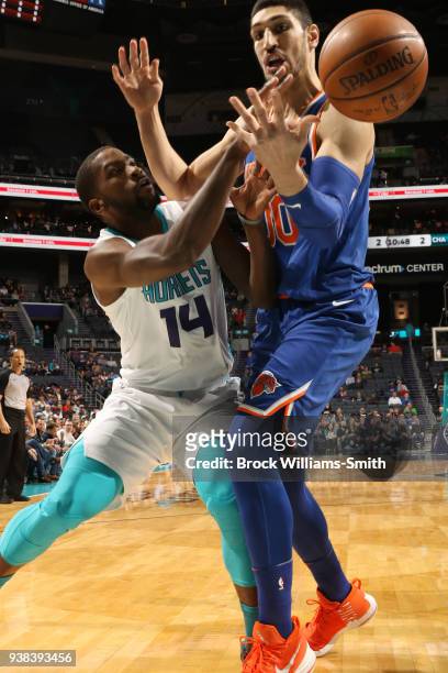 Michael Kidd-Gilchrist of the Charlotte Hornets passes the ball against Enes Kanter of the New York Knicks on March 26, 2018 at Spectrum Center in...