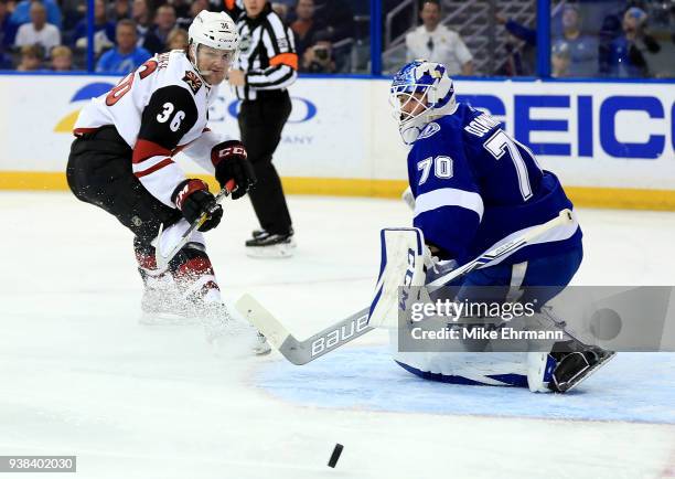 Christian Fischer of the Arizona Coyotes takes a shot on Louis Domingue of the Tampa Bay Lightning during a game at Amalie Arena on March 26, 2018 in...
