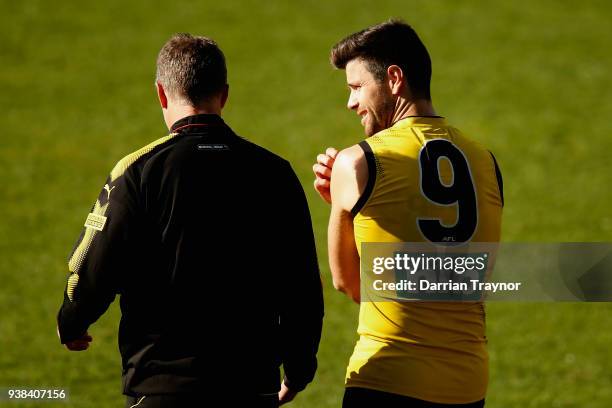 Damien Hardwick, Senior Coach of the Tigers speaks with captain Trent Cotchin during a Richmond Tigers AFL training session at Punt Road Oval on...