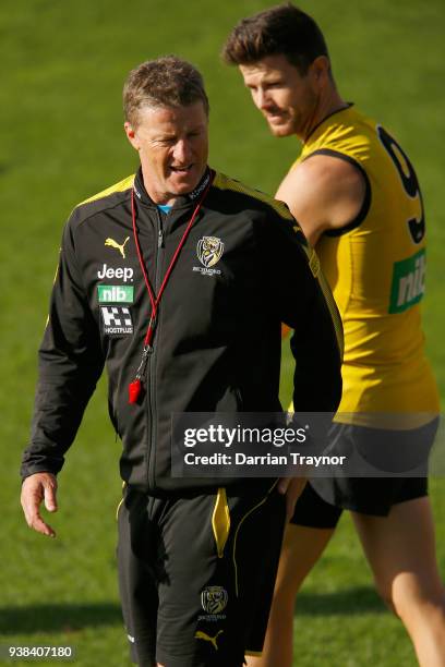 Damien Hardwick, Senior Coach of the Tigers speaks with captain Trent Cotchin during a Richmond Tigers AFL training session at Punt Road Oval on...