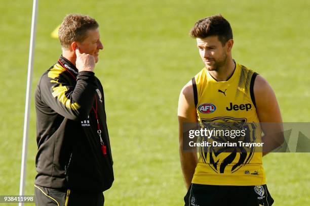 Damien Hardwick, Senior Coach of the Tigers speaks with captain Trent Cotchin during a Richmond Tigers AFL training session at Punt Road Oval on...